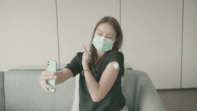 A young woman wearing a face mask smiles as she receives a vaccination. The setting is a modern health facility, reflecting a positive approach to health and well-being. - Powered by Shutterstock - Get 15% off with code: PIKWIZARD15