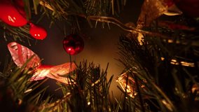 Dark View Through Tree Branches with Red Baubles and Berries Illuminated by Warm Lights Using Dolly Slider Effect Representing Cozy Festive Ambience. - Powered by Shutterstock - Get 15% off with code: PIKWIZARD15