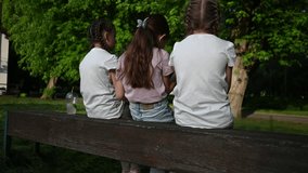 Three Young Girls Enjoying a Peaceful Summer Day Together on a Park Bench - Powered by Shutterstock - Get 15% off with code: PIKWIZARD15