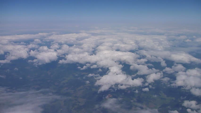 Flying in airplane over Portland Oregon to Pacific Ocean with clouds below and