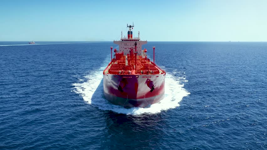 Aerial front view of a crude oil tanker or chemical goods traveling with high speed over the ocean