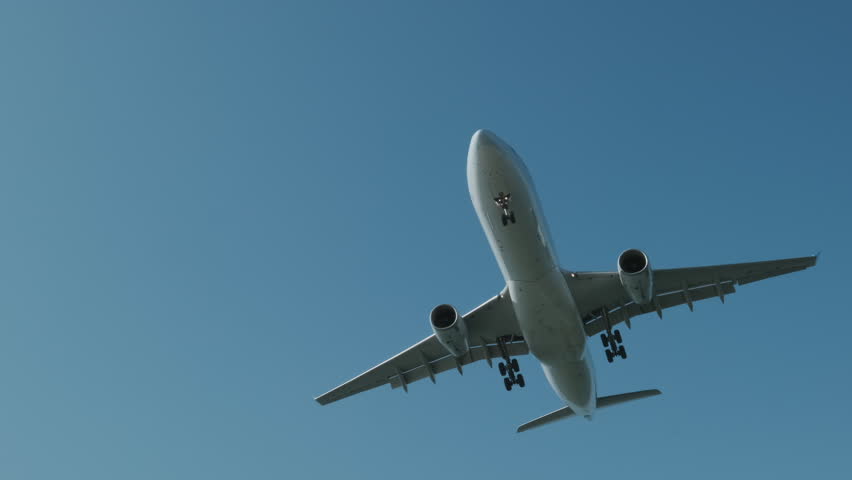 Cargo large airplane fly in blue sky before landing and landing lights