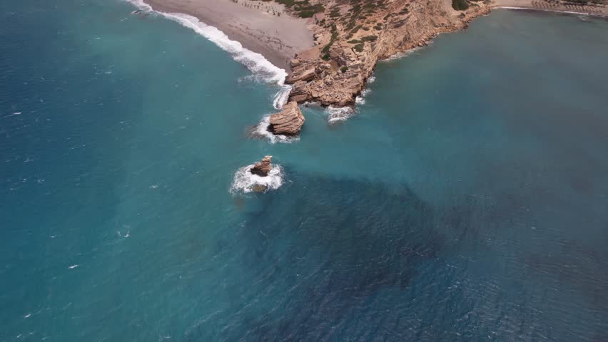 Aerial footage of Triopetra seaside bluff and its rugged coastline, located in the south of Crete, Greece