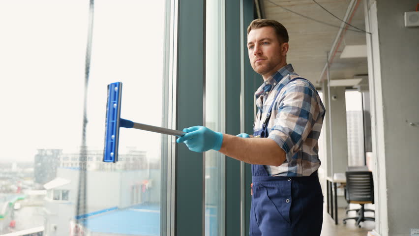 Professional cleaning service washing office windows