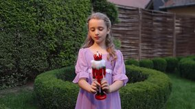 Girl in purple dress spinning with nutcracker toy - Powered by Shutterstock - Get 15% off with code: PIKWIZARD15