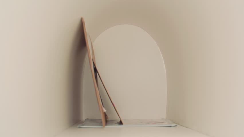 Girl in purple hoodie collecting several envelopes from mailbox and checking postal labels while standing outdoors on street