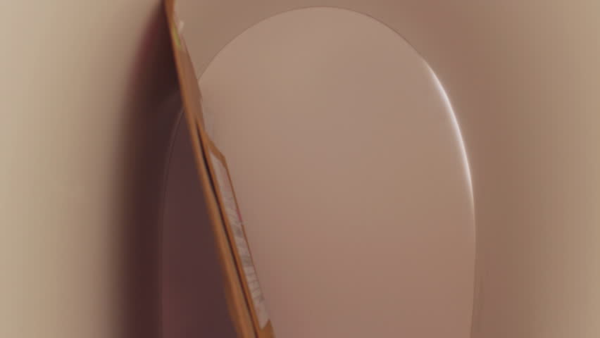 Man in denim jacket collecting envelopes from mailbox while standing outdoors on sunny day