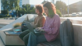 Students study outdoors on campus, communicating seriously while working on a laptop and notebook. They brainstorm and collaborate, building knowledge in a focused way. - Powered by Shutterstock - Get 15% off with code: PIKWIZARD15