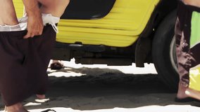 Nudist Men Arriving at Beach in Yellow Buggy and Removing Shorts, Low Angle View - 4K - Powered by Shutterstock - Get 15% off with code: PIKWIZARD15