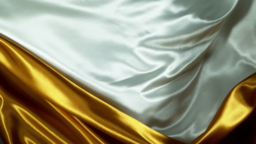 Super Slow Motion of Waving Golden and White Satin Cloth. Filmed on High Speed Cinema Camera, 1000 fps. Isolated on White Background.