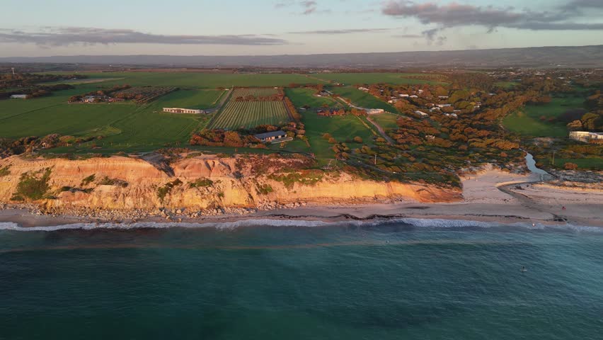 Port Willunga Beach, South Australia: 4K Aerial Drone Footage of Golden Cliffs, Golden Sand beach, Farmland Hills, Coastal Houses, Ocean Waves and Sunset Views