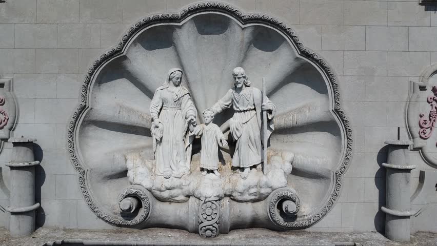 Dolly out starting at the Holy Family sculpture in the facade of the Parish of the Holy Family, neoclassical architechture in downtown Guadalajara. Guadalajara, Jalisco, México
