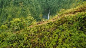 Hiker woman overlooking tall green cliffs and distant waterfall in Costa Rica - Powered by Shutterstock - Get 15% off with code: PIKWIZARD15