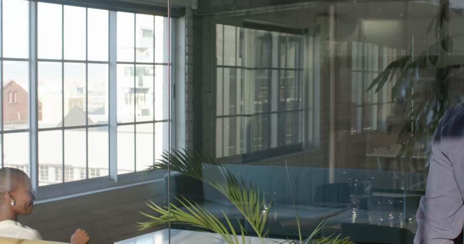 Walking in modern office with large windows, businesswoman having conversation. professional, corporate, discussion, workplace, skyscraper, networking