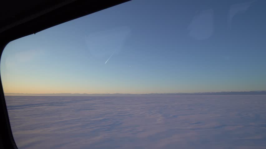 POV from vehicle window of epic Lake Baikal winter views. Frozen lake expanse with distant mountains, immersive travel experience, journey simulation, perfect for travel vlogs, social media content