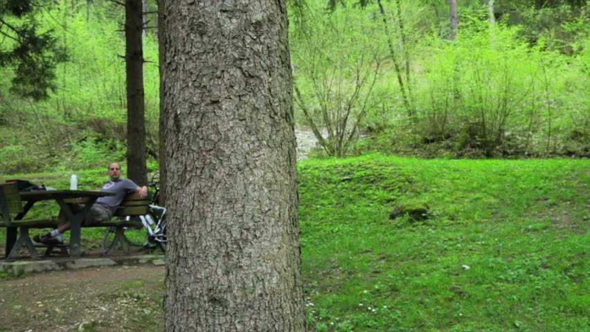 Man taking a break and relax of his trip on bicycle in countryside