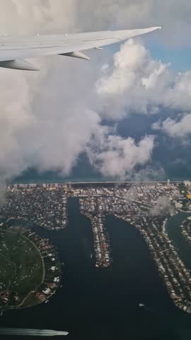 Vertical View, Flying Above Miami Beach and Clouds, Airplane Passenger Point of View, Florida USA