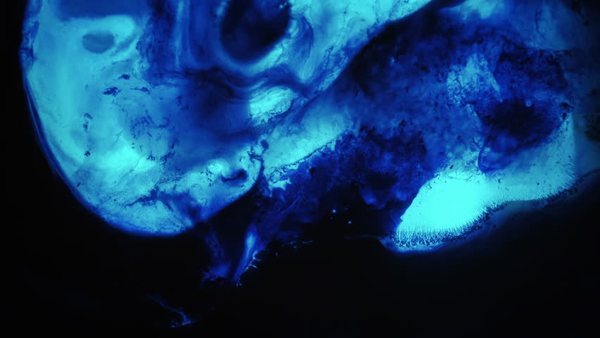 Wet oil. Liquid flow spill. Defocused dark black blue color water drop neon paint blob spreading on abstract art light background.