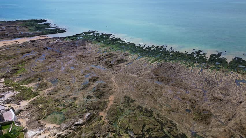 Aerial view of Plage de Bonne Source beach during low tide, Pornichet, France. Aerial forward descending