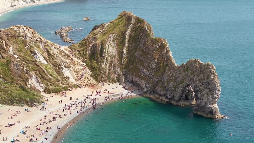 Aerial view showing tourists relaxing and swimming at Durdle Door on the Jurassic Coast