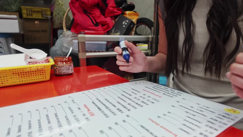 Cropped View Of A Woman Ordering Food At The Market Stall In Taiwan. Close-up Shot