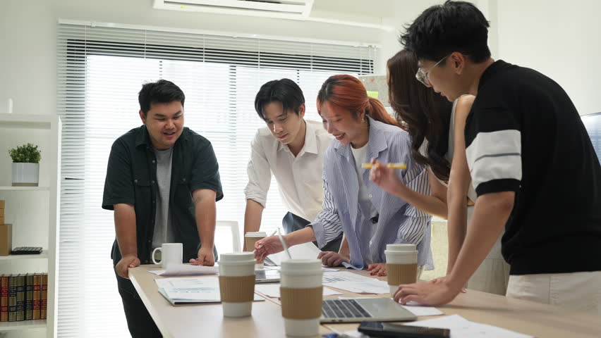 During an agile hackathon, a closeup of hands shows a team using data analytics for strategic insights. This collaboration drives innovation and digital transformation.