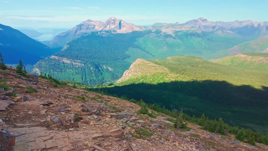 A breathtaking view captures Grinnell Glacier and Upper Grinnell Lake from a scenic overlook in Glacier National Park