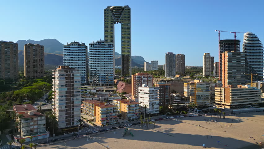 Aerial drone view of the buildings along the coastline and the sea in Benidorm, Spain in daylight