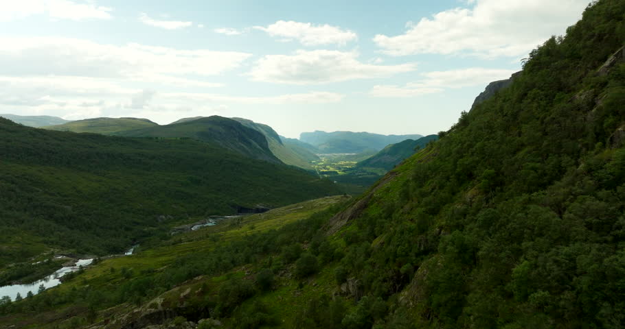 Lush green landscape in Norway. Aerial forward, copy space