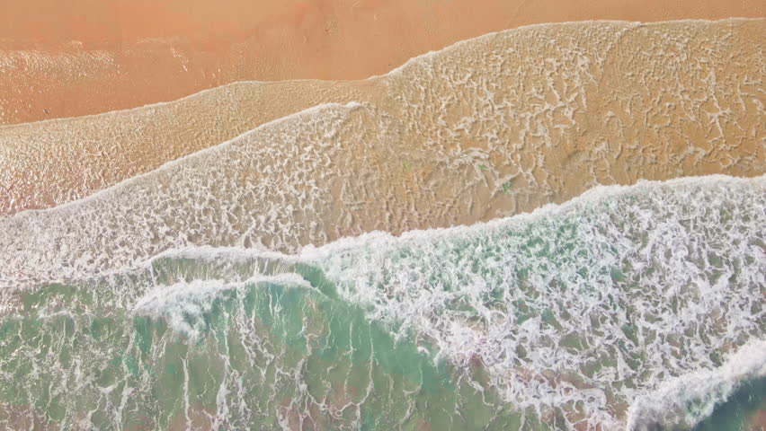 Aerial top view of ocean waves along sandy shoreline, serene coastal retreat with blue sea, beach tranquility and scenic seascape beauty at Koh kood Thailand