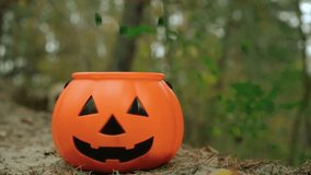 Colorful candies fall into a glowing Halloween pumpkin bucket, creating a festive trick-or-treat scene. Perfect for party invitations, seasonal greetings, stock footage, and children’s Halloween fun. - Powered by Shutterstock - Get 15% off with code: PIKWIZARD15