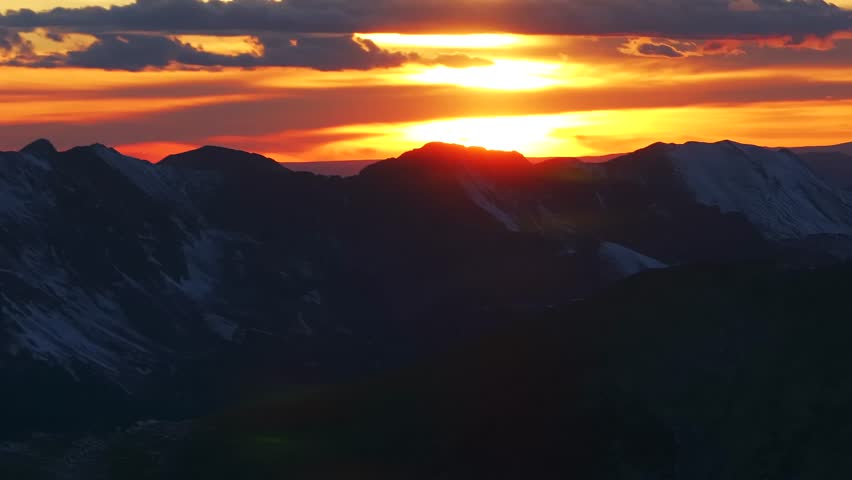 Glowing Rocky Mountains sunset Mt Mount Shavano Elbert Huron La Plata Tabeguache Antero Peak Colorado aerial drone fall autumn snow Sawatch Range top of summit sun on horizon clouds parallax circle