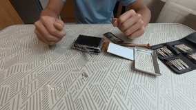Child using precision screwdriver to repair small electronic device. Close-up of hands fixing gadget with toolkit on table, learning technical skills - Powered by Shutterstock - Get 15% off with code: PIKWIZARD15