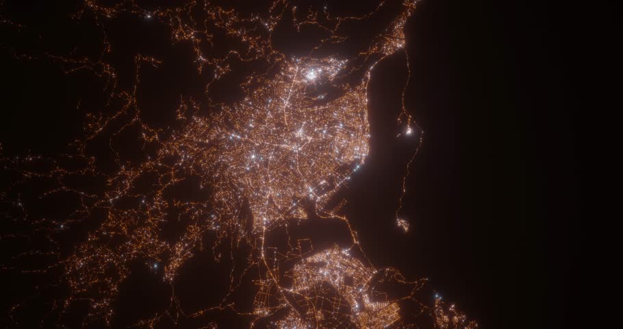 Kingston (Jamaica) aerial view at night. Top view on modern city with street lights. Camera is zooming out, rotating clockwise. Vertical video. The north is on the left side