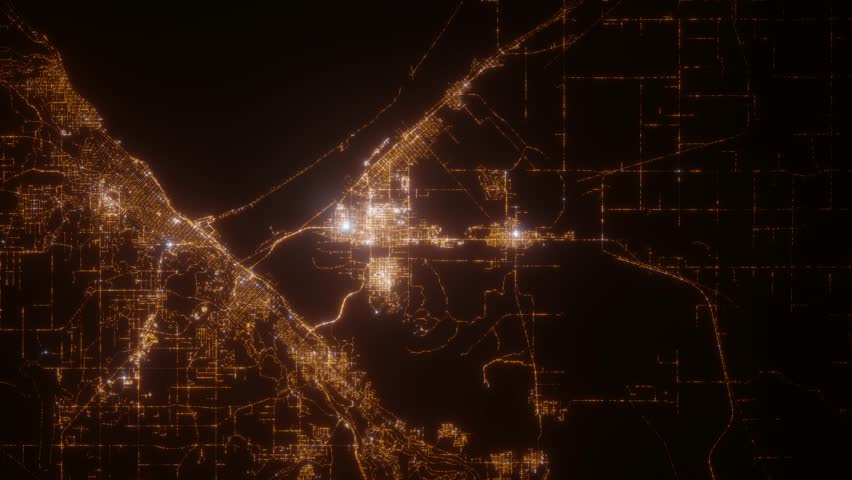 Duluth (Minnesota, USA) top view at night. Aerial view on modern city from space. Camera is flying above the city, moving forward. Vertical video. The north is on the left side