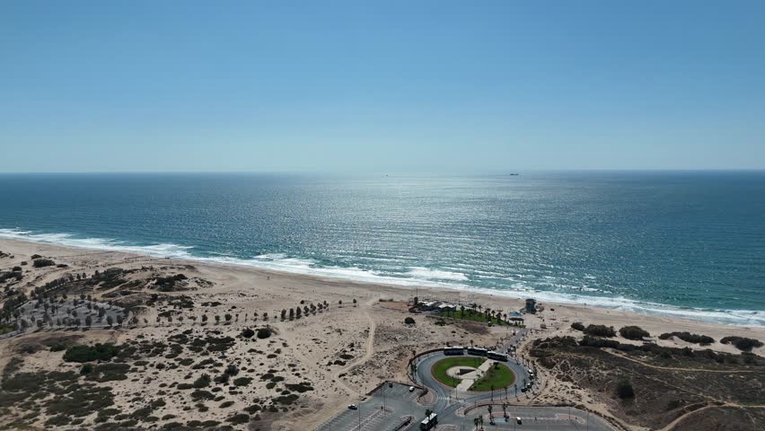 Aerial 4K drone footage of Ashdod beach, showing sandy shores, blue Mediterranean waters, and a relaxing coastal view.
