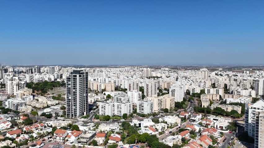 Drone 4K aerial footage of Ashdod city, capturing the urban streets, buildings, and coastal skyline from above.