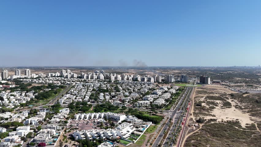 Aerial 4K drone footage capturing the cityscape of Ashdod, showing streets, buildings, and urban life from above.