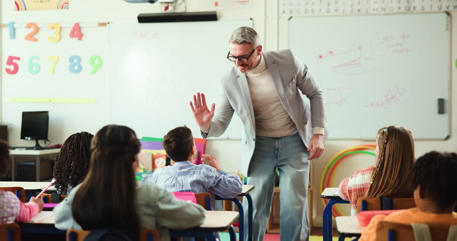 High five, education and man in school, students and support with knowledge, growth and success. Teacher, group and kids in classroom, learning and child development with motivation and well done