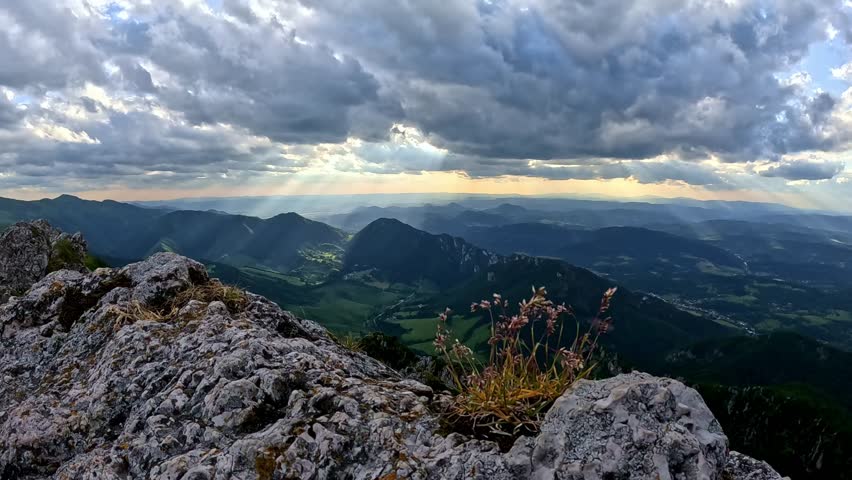  Slow-motion of dramatic clouds and wind-blown grass on a rocky mountain peak