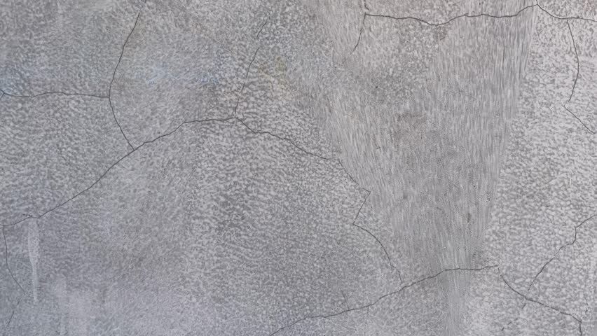 Closeup of old damaged wall texture with cracks, weathered surface detail.