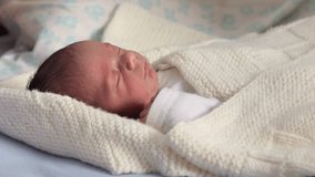 Newborn baby sleeping peacefully in white knitted blanket - Powered by Shutterstock - Get 15% off with code: PIKWIZARD15