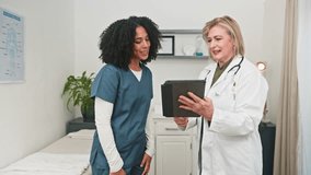 Diverse Healthcare Professionals Celebrate Success and Teamwork With a High-Five During a Doctor Consultation - Powered by Shutterstock - Get 15% off with code: PIKWIZARD15