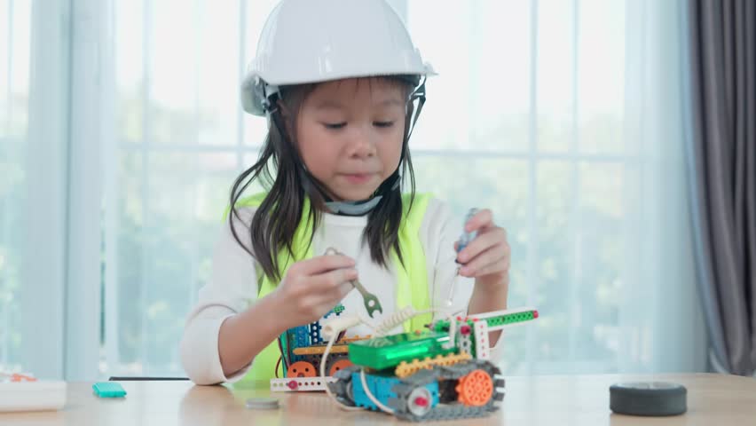 Young Engineers: multi ethnic Children engrossed in building and testing small robotics, showcasing curiosity, teamwork, and early STEM education. The focus robot and children hands-on engagement.