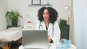 Professional Diverse Female Doctor Engaged in Online Telemedicine Consultation via Laptop in Clinic - Powered by Shutterstock - Get 15% off with code: PIKWIZARD15