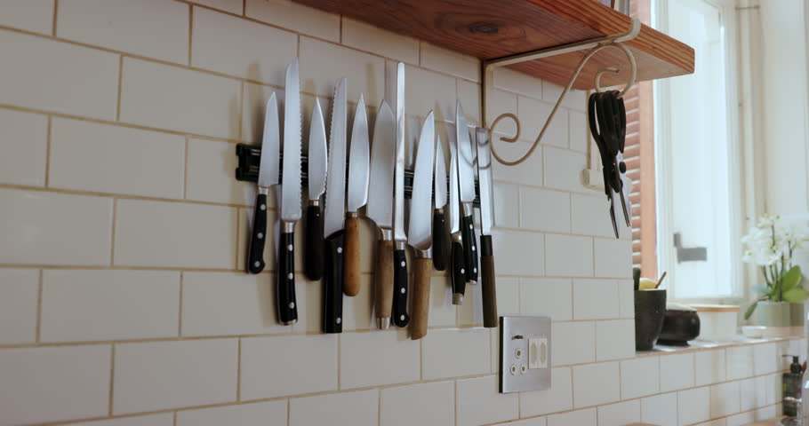 Kitchen, wall and magnetic knife holder with cooking equipment for catering in small business. Steel blade, culinary tools and storage of utensils, metal cutlery and arrangement in restaurant