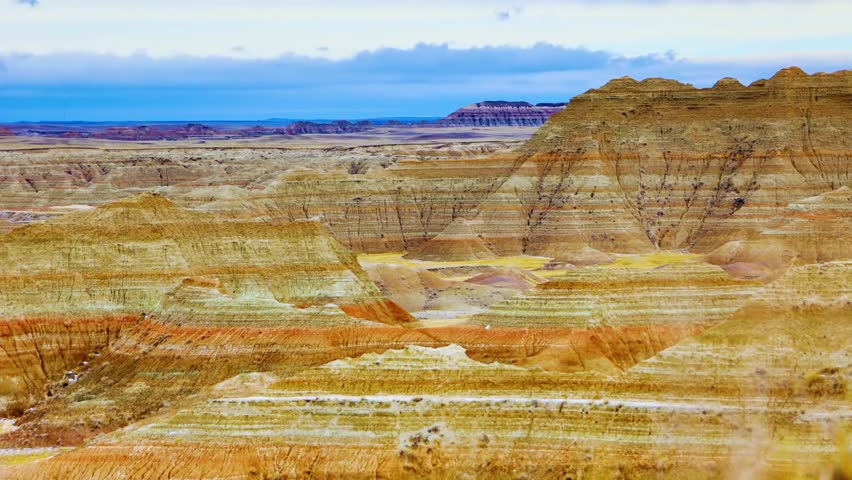 Badlands National Park in southwestern South Dakota showcases dramatic natural beauty with rugged rock formations, layered sedimentary cliffs, deep canyons, and vast open plains. A breathtaking American landscape highlighting erosion patterns, geological history, and untouched wilderness under natural light.