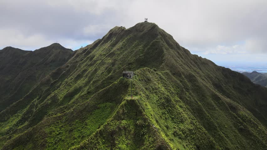 Aerial footage of Oahu's Stairway to Heaven shows the dramatic ridge, lush mountains, and iconic Haiku Stairs rising into the clouds.