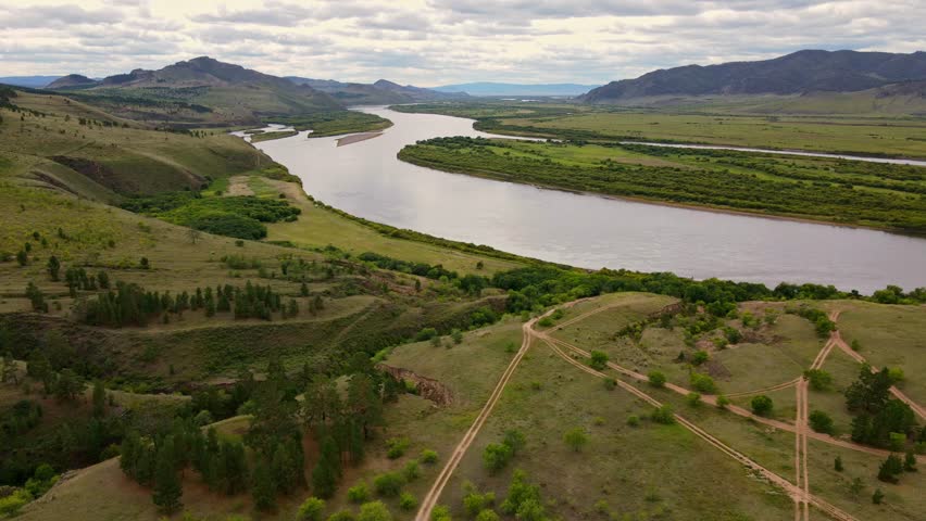 Scenic river valley view with rolling hills and lush greenery in Montana