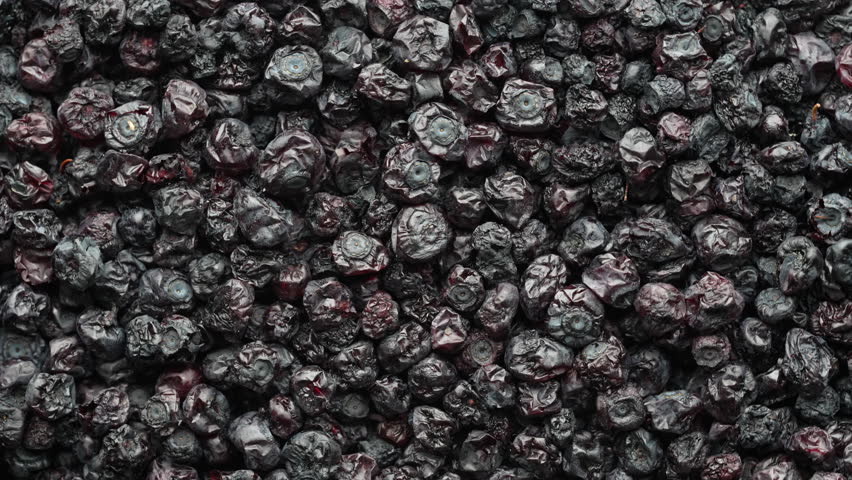 Dried wild blueberries background, rotates, close up, top view, macro. Pile of dry blueberry from dehydrator. Concept of preserving vitamins for winter, healthy eating